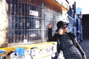 Kitty Solaris Pressefoto an Gitter mit Streetart